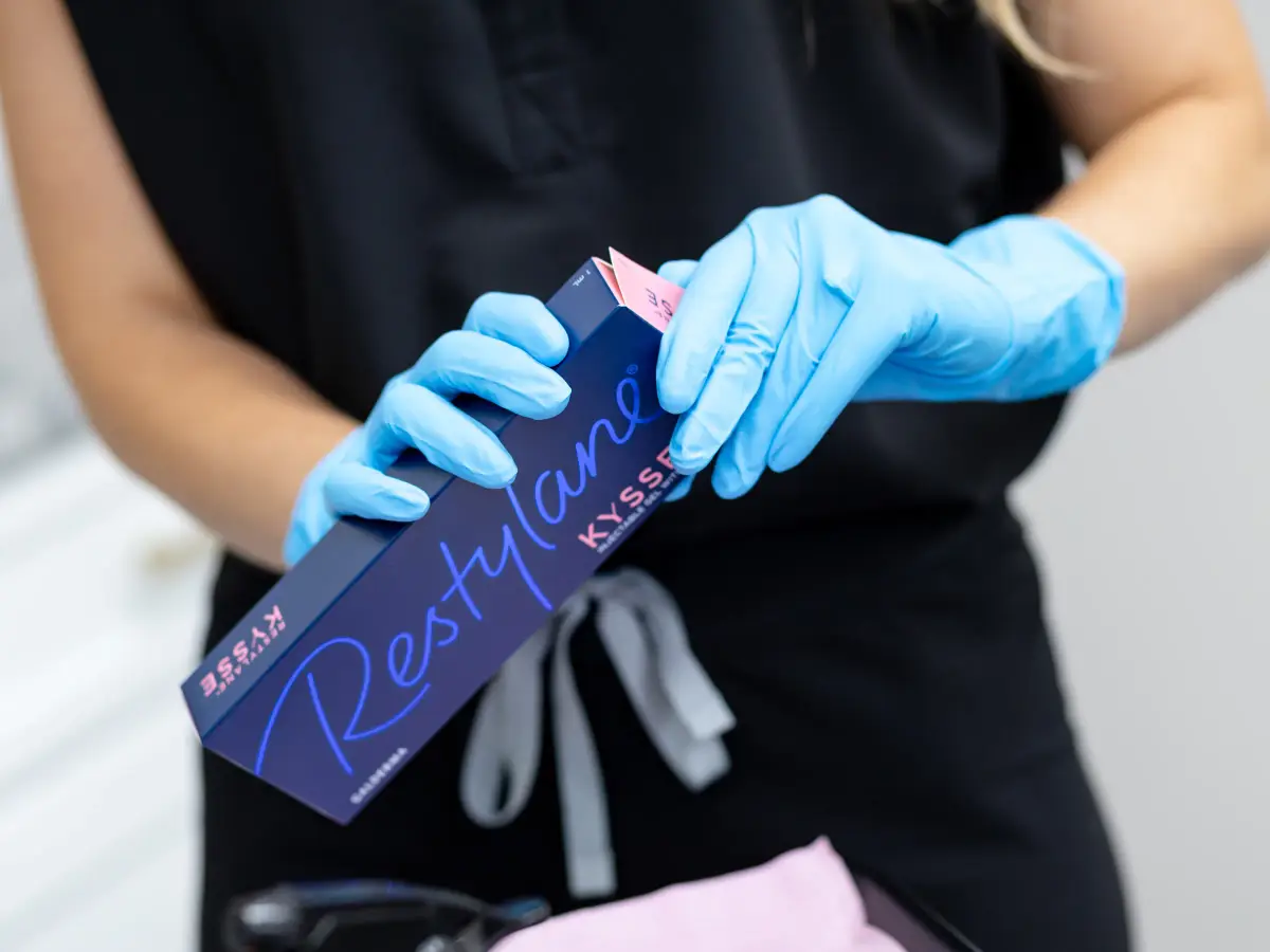 A gloved Pura Vida provider holding a box of Restylane Kysse in Fleming Island, FL