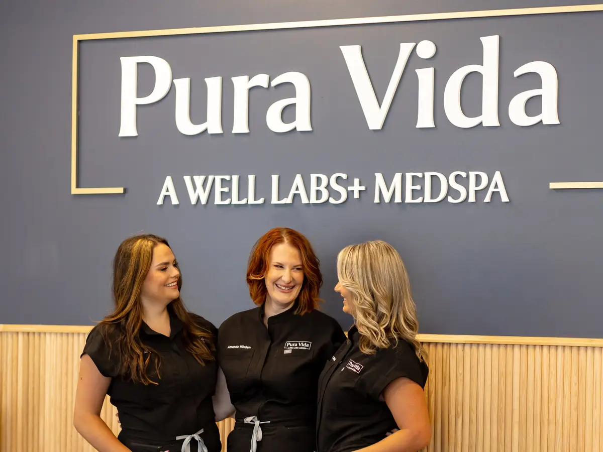 Three Pura Vida providers at the front desk of the Fleming Island, FL medspa